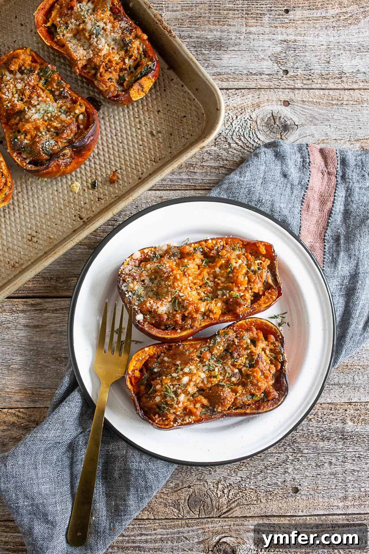 Savory Stuffed Honeynut Squash 4 A serving of stuffed honeynut squash, beautifully plated on a white dish, garnished with fresh herbs, highlighting the golden roasted squash and rich filling.