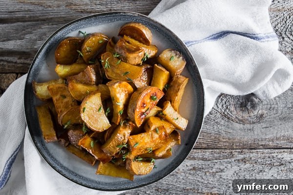 Roasted White Sweet Potatoes on a serving board, showcasing their golden glaze.