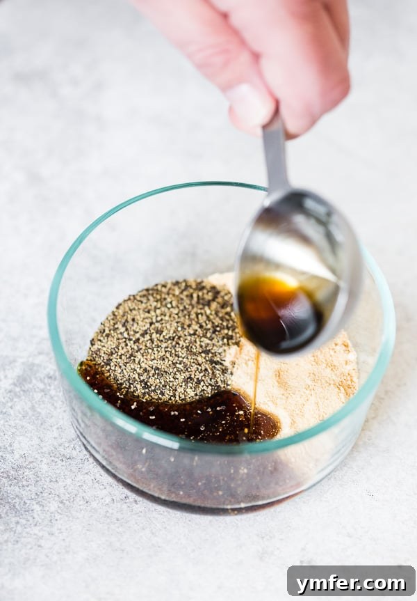 Pouring golden maple syrup into a bowl, ready to be mixed with spices for the bacon glaze.