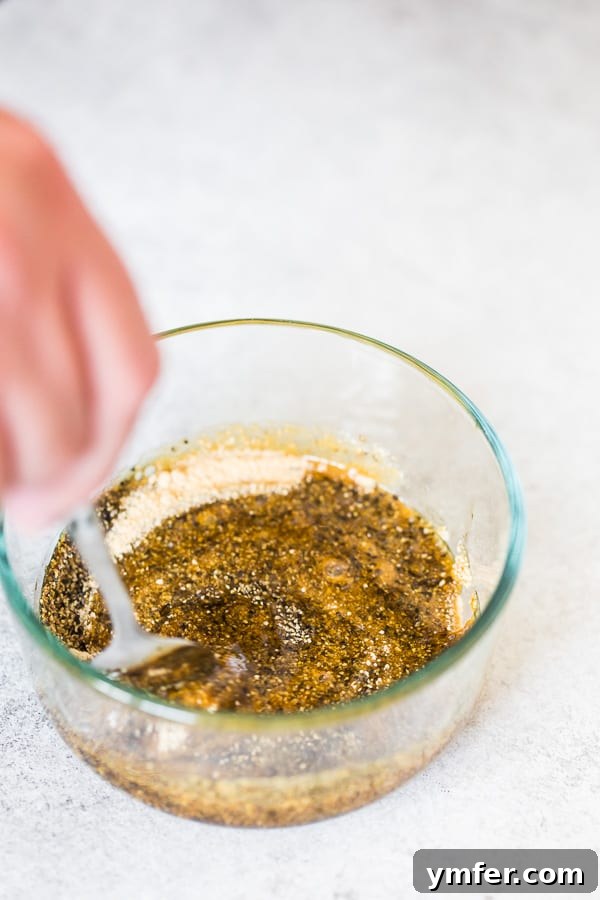 A bowl with maple syrup, maple sugar, and black pepper, being mixed for the delicious glaze.