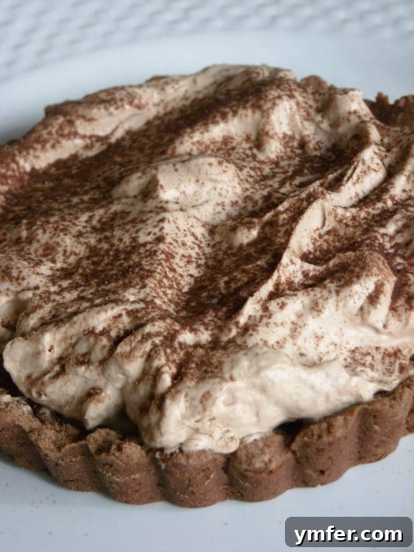 A decadent Milky Way Tart, featuring luscious chocolate and rich caramel flavors. This sweet and creamy milky way tart gives you all the flavors of the candy bar in tart form. You're going to love all this chocolate and caramel goodness.