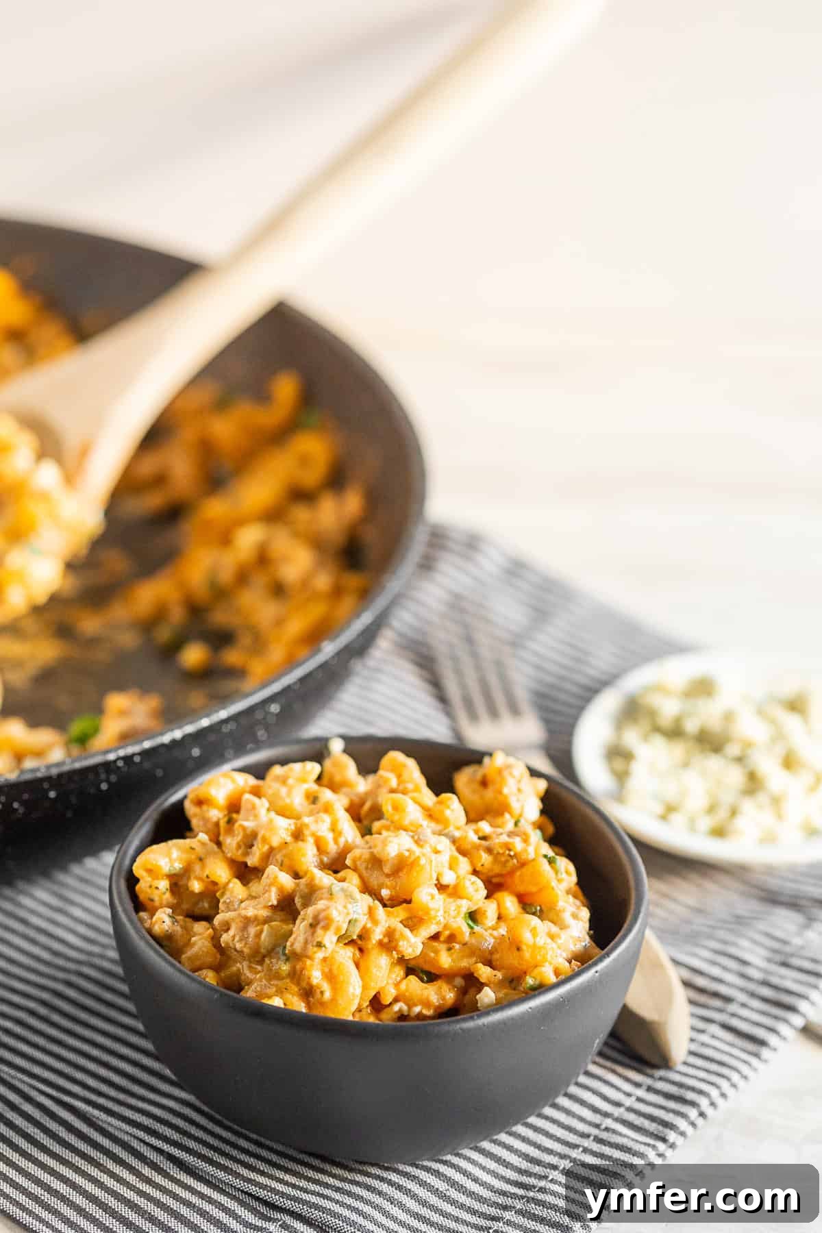 Creamy One Pot Buffalo Chicken Pasta 5 A serving of creamy One Pot Buffalo Chicken Pasta in a rustic black bowl, ready to be enjoyed.