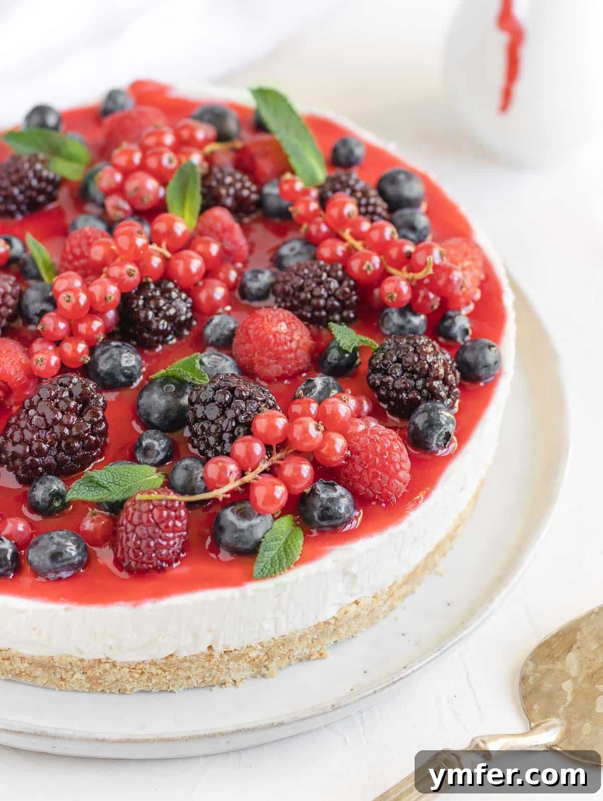 Creamy No-Bake Vegan Cheesecake 2 Decadent no-bake vegan cheesecake topped with fresh berries, ready to be served.
