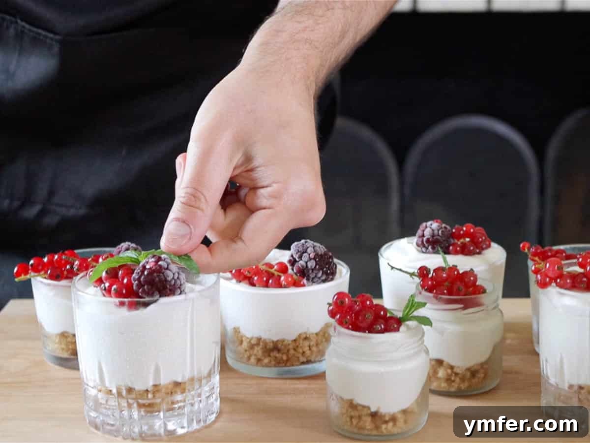 Creamy No-Bake Vegan Cheesecake 13 Mono-portioned vegan cheesecakes served in small glasses with berry topping.