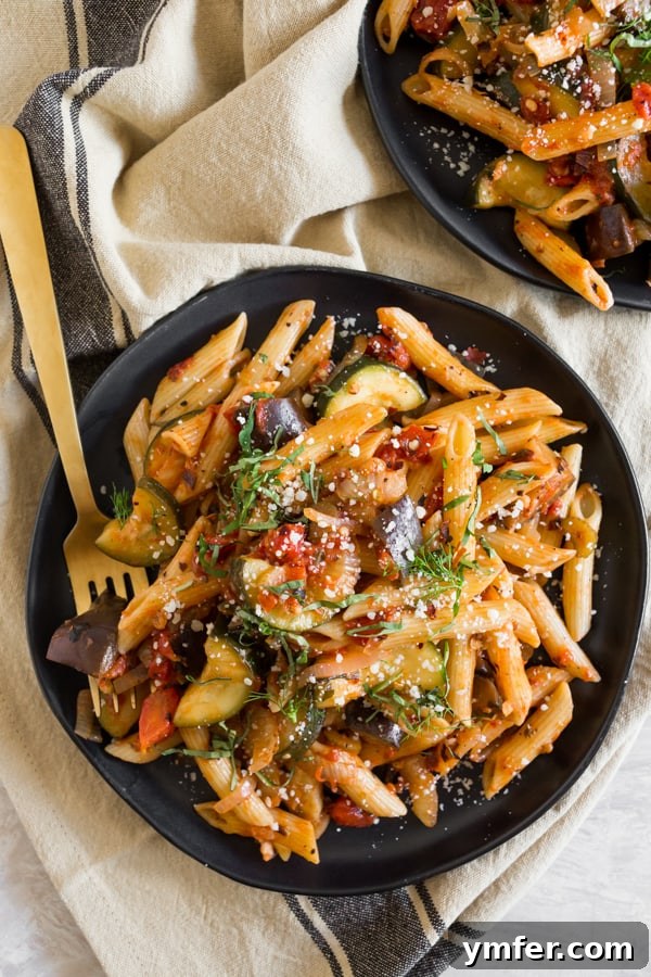 Provencal Pasta Medley 2 Two plates of colorful Ratatouille Pasta garnished with fresh basil.