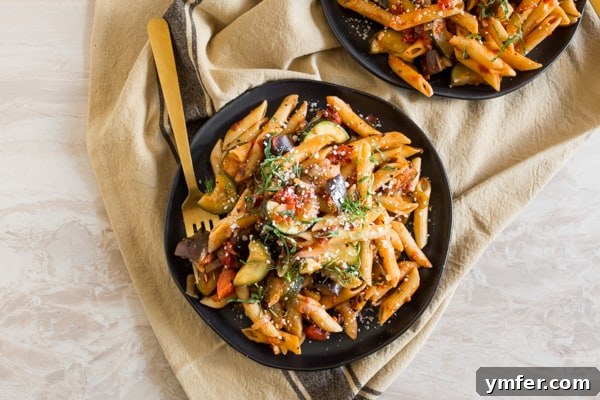 Provencal Pasta Medley 5 A serving of Ratatouille Pasta on a plate with a fork, ready to eat.