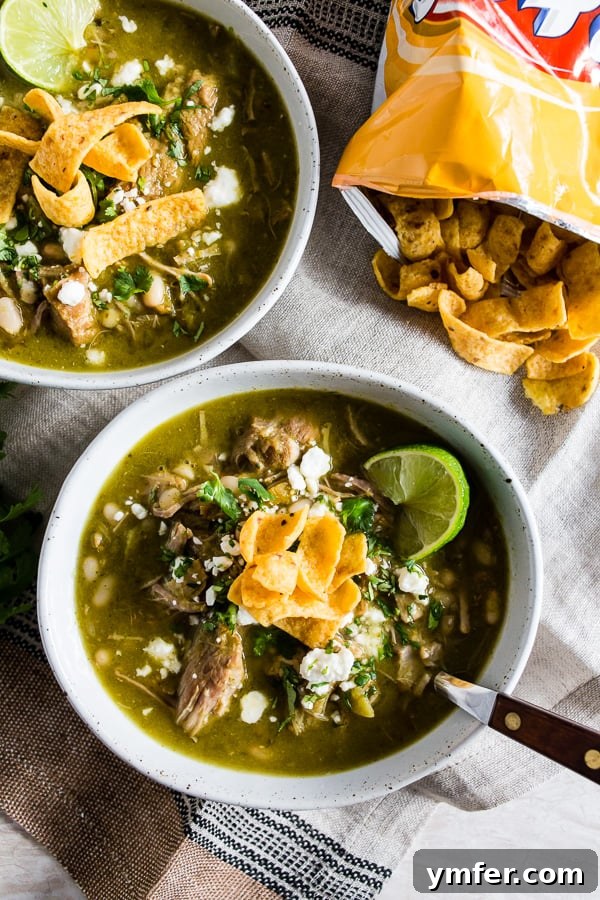 Zesty Instant Pot Pork Chili Verde 3 A close-up shot of Instant Pot Pork Chili Verde in a bowl, generously topped with golden corn chips, ready to be enjoyed.