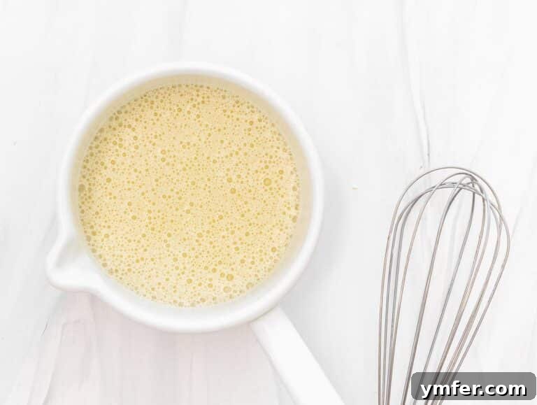 thickening liquid in a pot without lumps, being whisked continuously