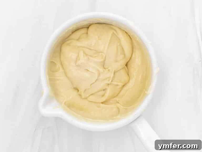 final vegan cheese mixture in a pot, showcasing its smooth and stringy texture