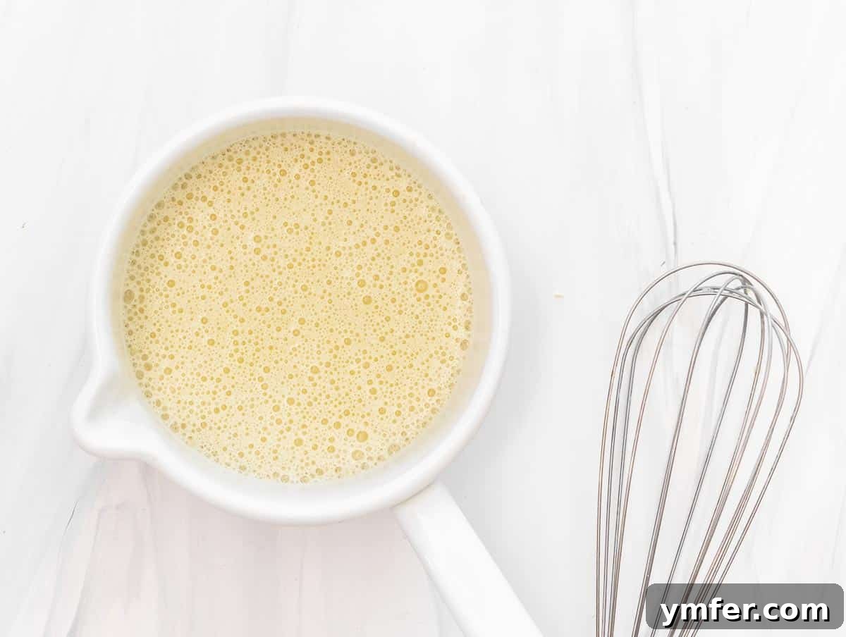 5-Minute Nut-Free Vegan Cheese Recipe 6 all ingredients for vegan cheese being mixed in a pot with a whisk