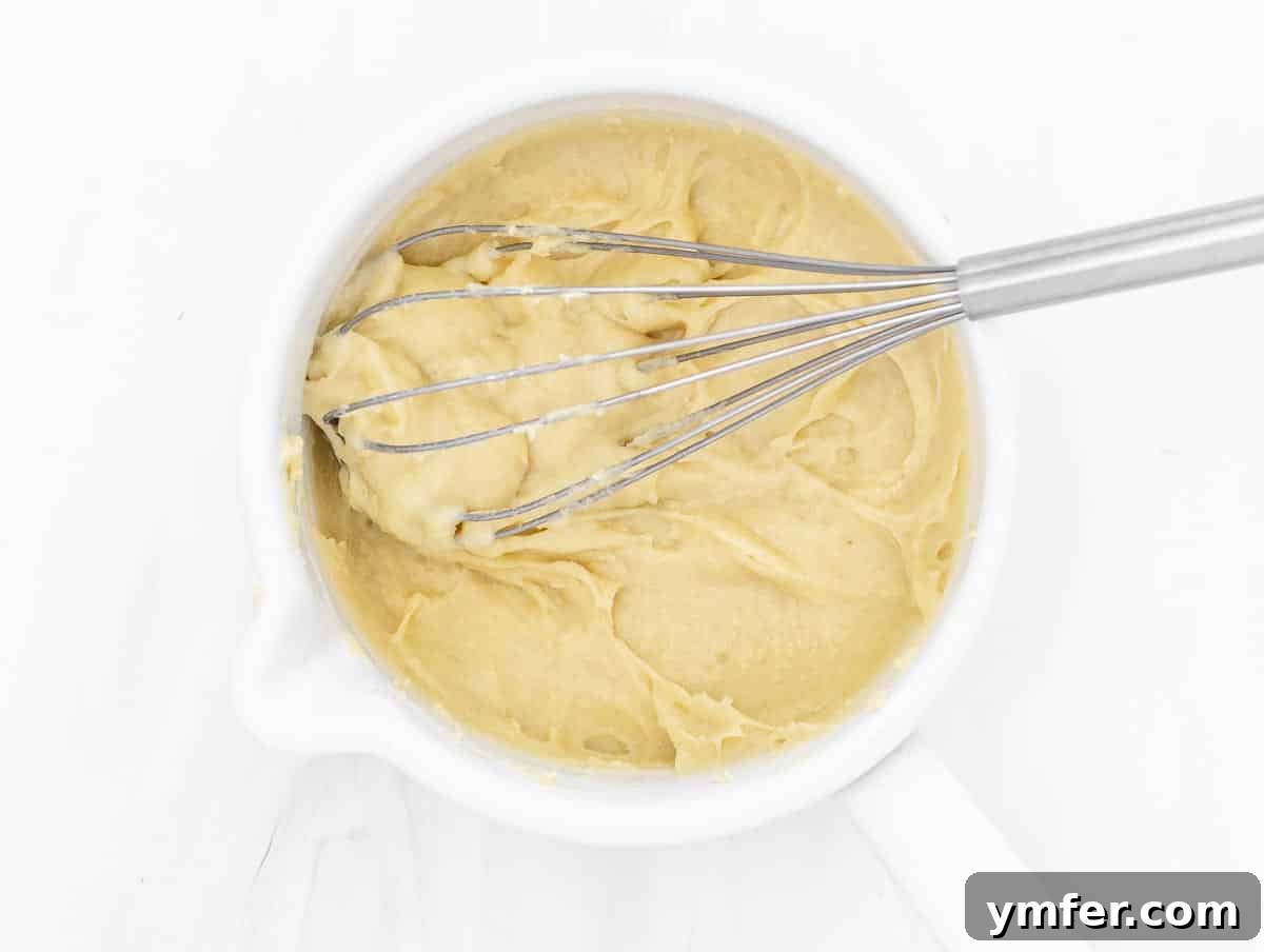5-Minute Nut-Free Vegan Cheese Recipe 7 thick and gluey vegan cheese mixture in a pot after heating