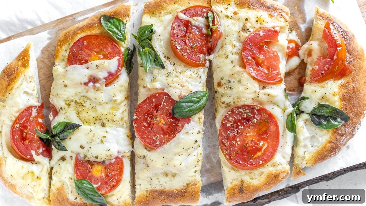 5-Minute Nut-Free Vegan Cheese Recipe 10 flatbread pizza topped with melted vegan cheese and fresh tomatoes