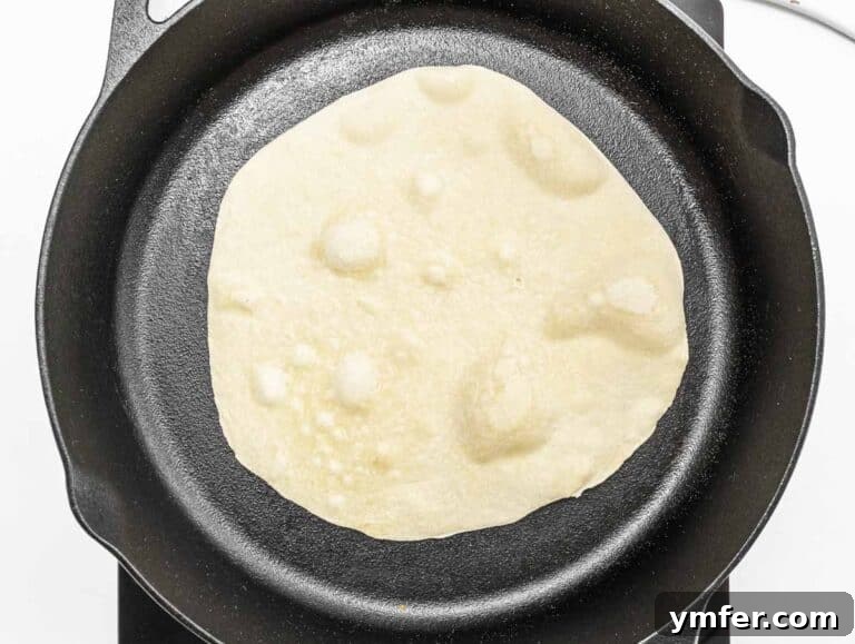 cooking the piadina on a cast iron skillet