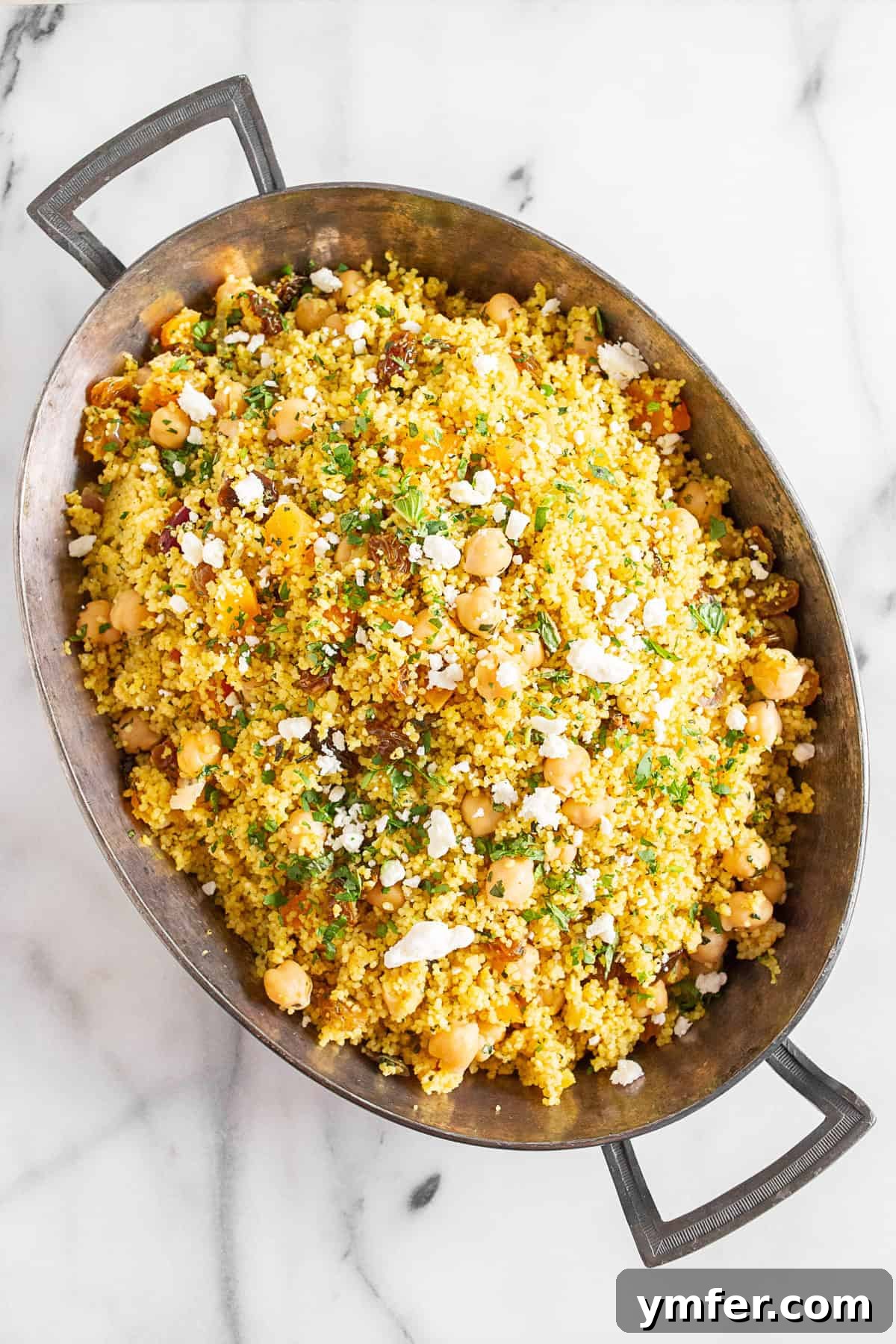 Vibrant Moroccan Chickpea Couscous 4 Moroccan Couscous in a metal baking dish, ready to be served.