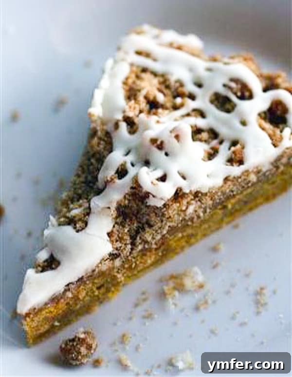 Golden Spiced Pumpkin Coffee Cake Drizzled with Brown Butter Glaze 3 A delectable slice of pumpkin coffee cake with a generous brown butter glaze, perfect for a cozy fall day.