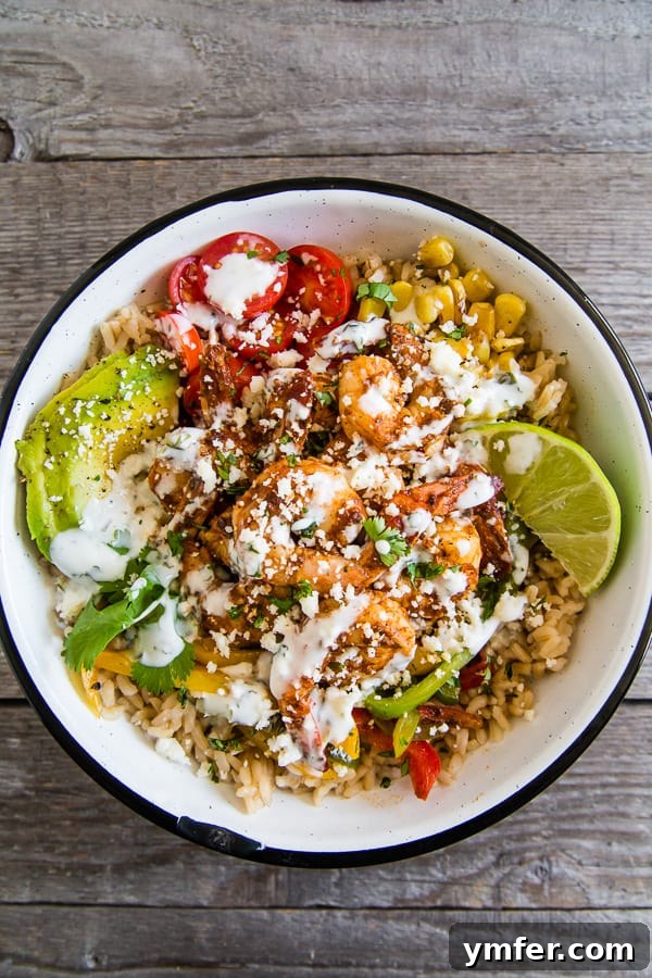 Bold Chipotle Shrimp Fajita Bowls 2 Delicious Chipotle Shrimp Fajita Bowls served generously with a creamy cilantro lime yogurt sauce and fresh toppings.