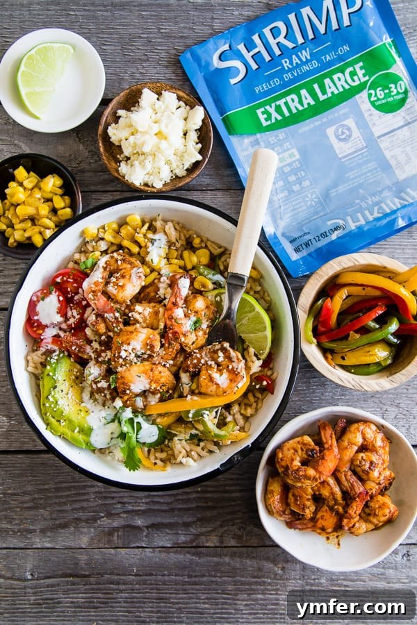 Bold Chipotle Shrimp Fajita Bowls 3 Individual Chipotle Shrimp Fajita Bowls generously topped with fresh avocado slices, cherry tomatoes, and crumbled Cotija cheese, ready to be enjoyed.