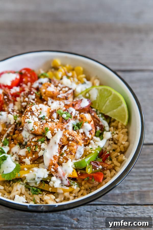 Bold Chipotle Shrimp Fajita Bowls 4 A beautifully arranged Chipotle Shrimp Fajita Bowl presented in a rustic, large white bowl, highlighting the colorful ingredients and the rich textures.