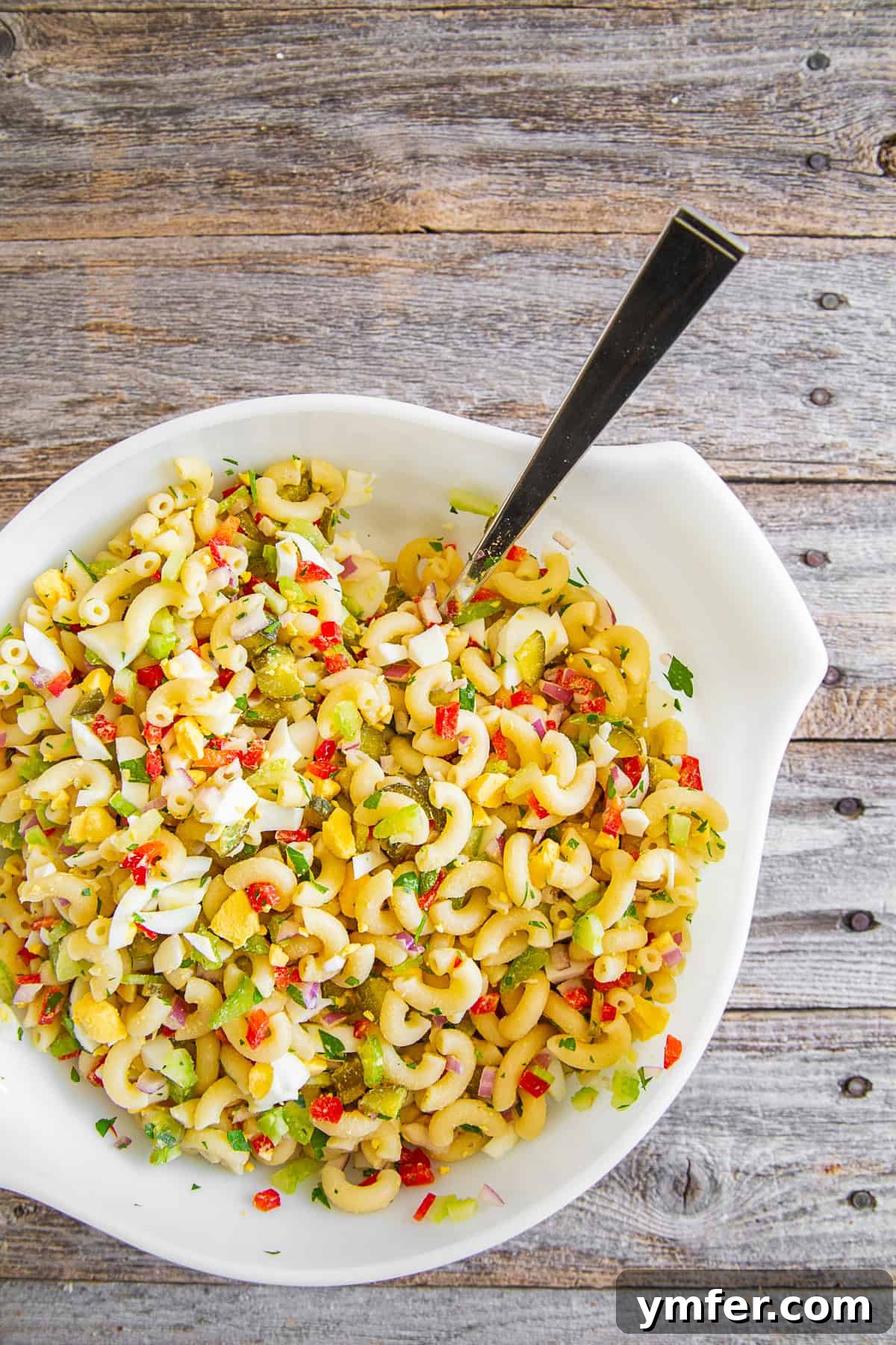 Grandma's Macaroni Salad 4 Classic Macaroni Salad ingredients mixed together in a bowl, before the dressing is added.