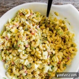This classic macaroni salad is packed full of crunchy vegetables, hard-boiled eggs, and a homemade dressing made out of yellow mustard, mayonnaise, and pickle juice. It's the perfect old fashioned Easter side dish or a delicious summertime cookout addition.