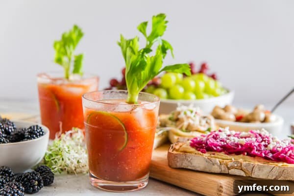 A single Horseradish Bloody Mary cocktail on a table with a white background, highlighting its simple elegance.