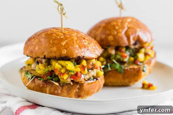 Chipotle Chicken Burgers Topped with Mango Salsa on a bun. 