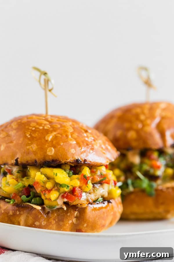 Chipotle Chicken Burgers Topped with Mango Salsa served on a brioche bun. 