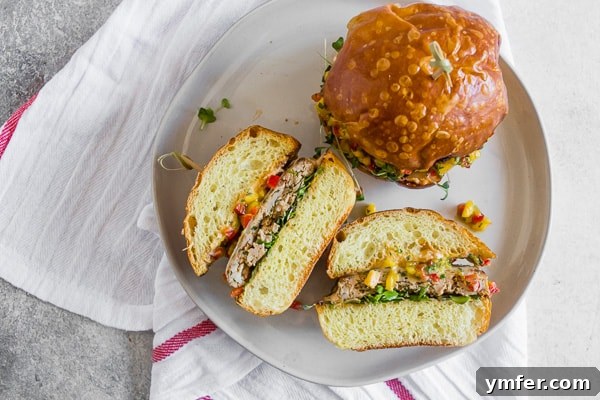 Chipotle Chicken Burgers Topped with Mango Salsa cut in half. 