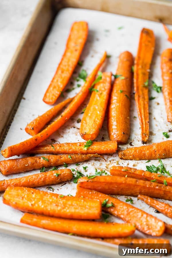 Golden Roasted Carrots, Effortlessly Delicious 3 best easy roasted carrots spread on a sheet pan before going into the oven