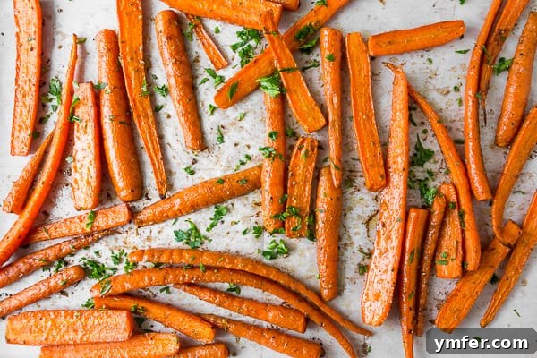 Golden Roasted Carrots, Effortlessly Delicious 5 best easy roasted carrots on a sheet pan, just out of the oven, with parsley garnish