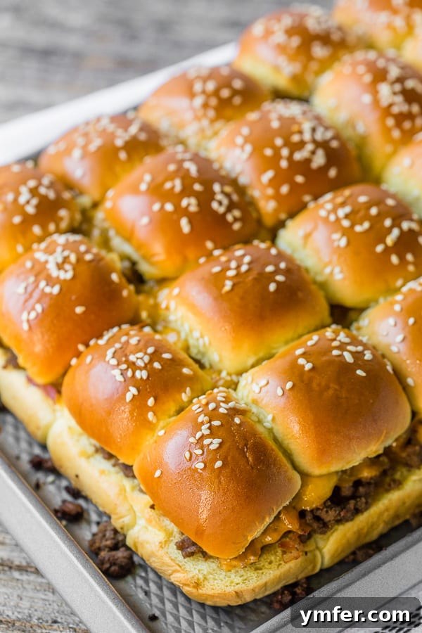 Cheesy Bacon Pull-Apart Sliders 4 A full sheet pan filled with perfectly baked bacon cheeseburger sliders, glistening with butter and sesame seeds.