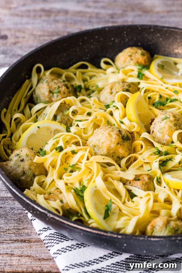 Zesty Baked Chicken Francese Meatballs 4 Baked Chicken Francese Meatballs simmering in a pan with pasta