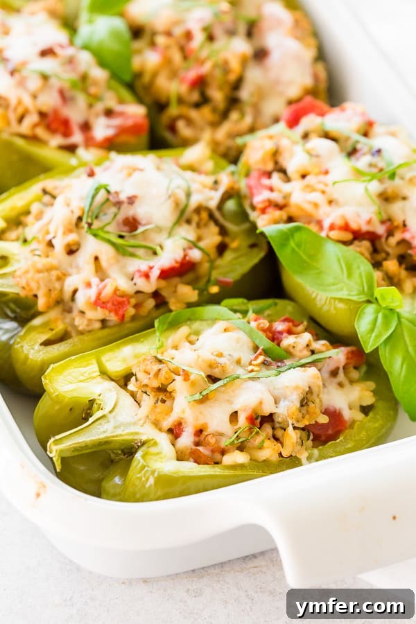 Savory Chicken Stuffed Bell Peppers 6 A baking dish filled with Italian Ground Chicken Stuffed Bell Peppers, their toppings perfectly melted and golden