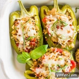 ground chicken stuffed bell peppers in a white dish