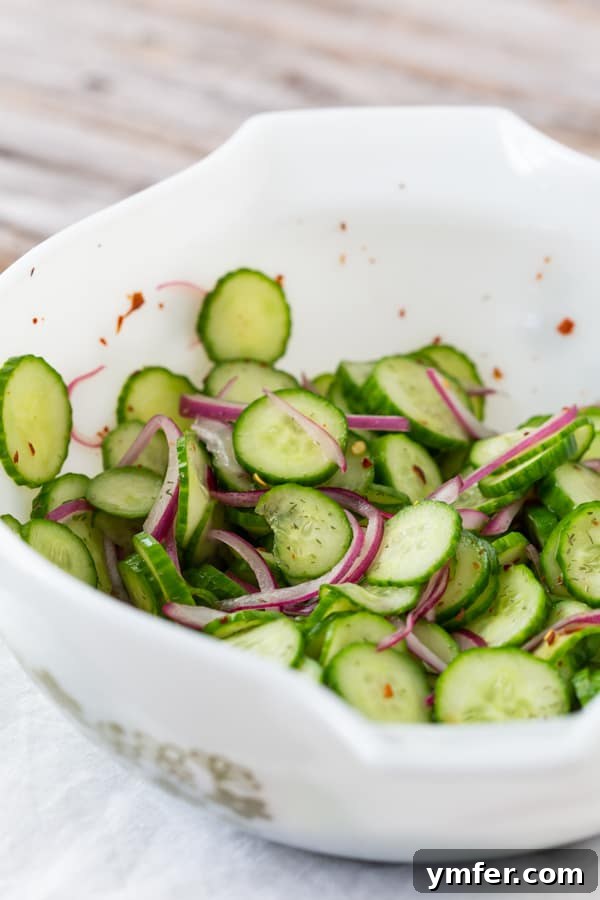 Crisp and Cool Cucumber Salad 6 A simple yet elegant white bowl holding a generous portion of sweet vinegar cucumber salad.