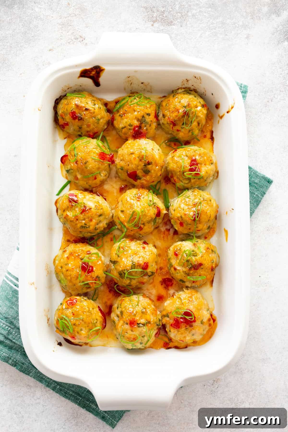 Effortless Thai Baked Chicken Meatballs 2 Easy Thai Baked Chicken Meatballs in a white casserole dish.