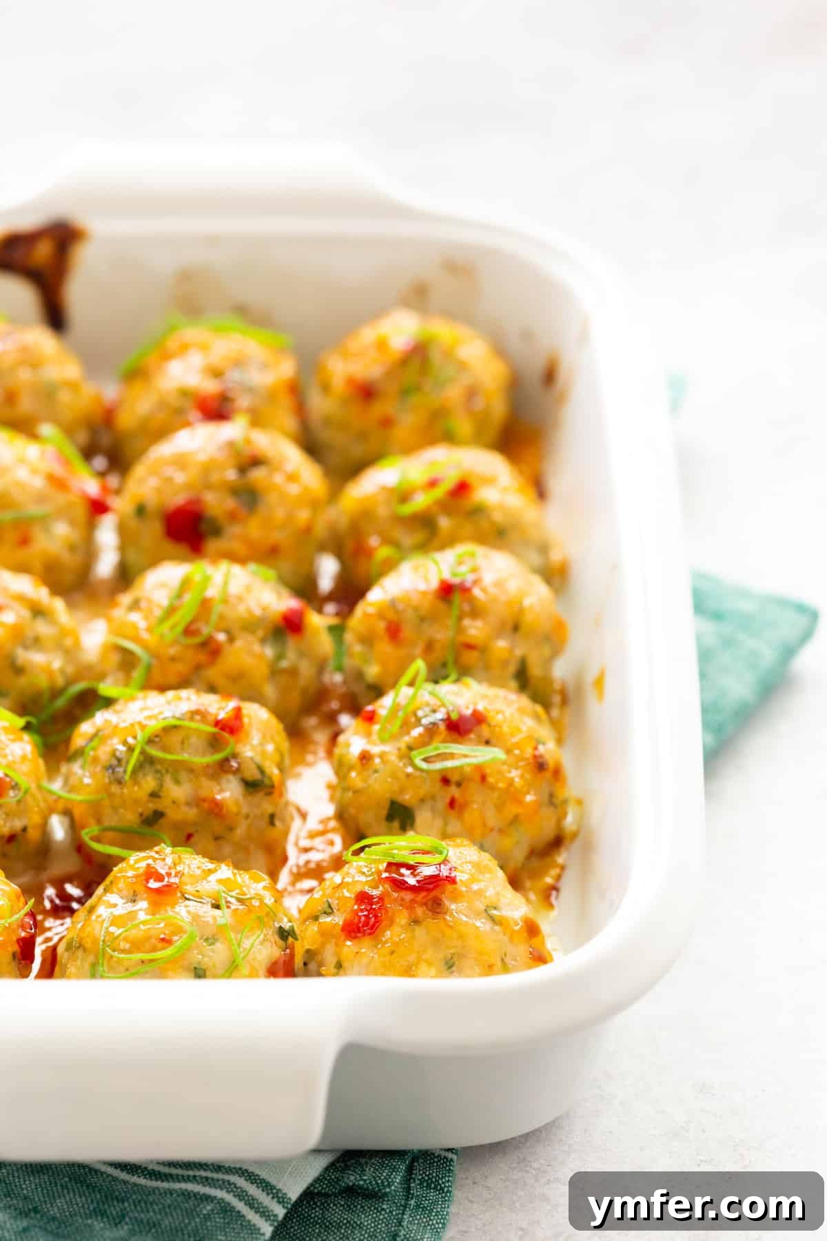 Effortless Thai Baked Chicken Meatballs 6 Easy Thai Baked Chicken Meatballs in a baking dish, fresh from the oven.