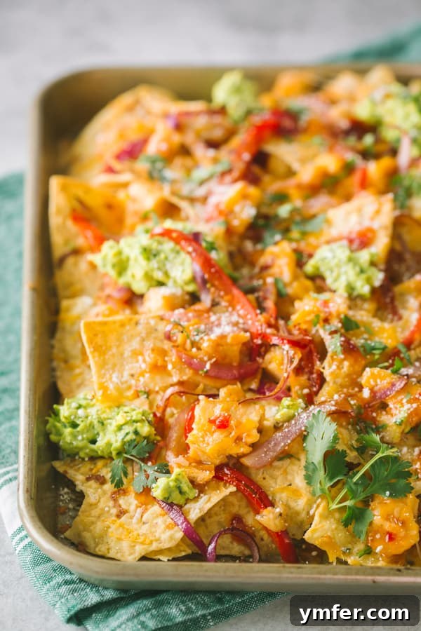 Sweet Heat Thai Chicken Nachos 4 Thai sweet chili chicken nachos topped with avocado and cilantro, ready to serve.