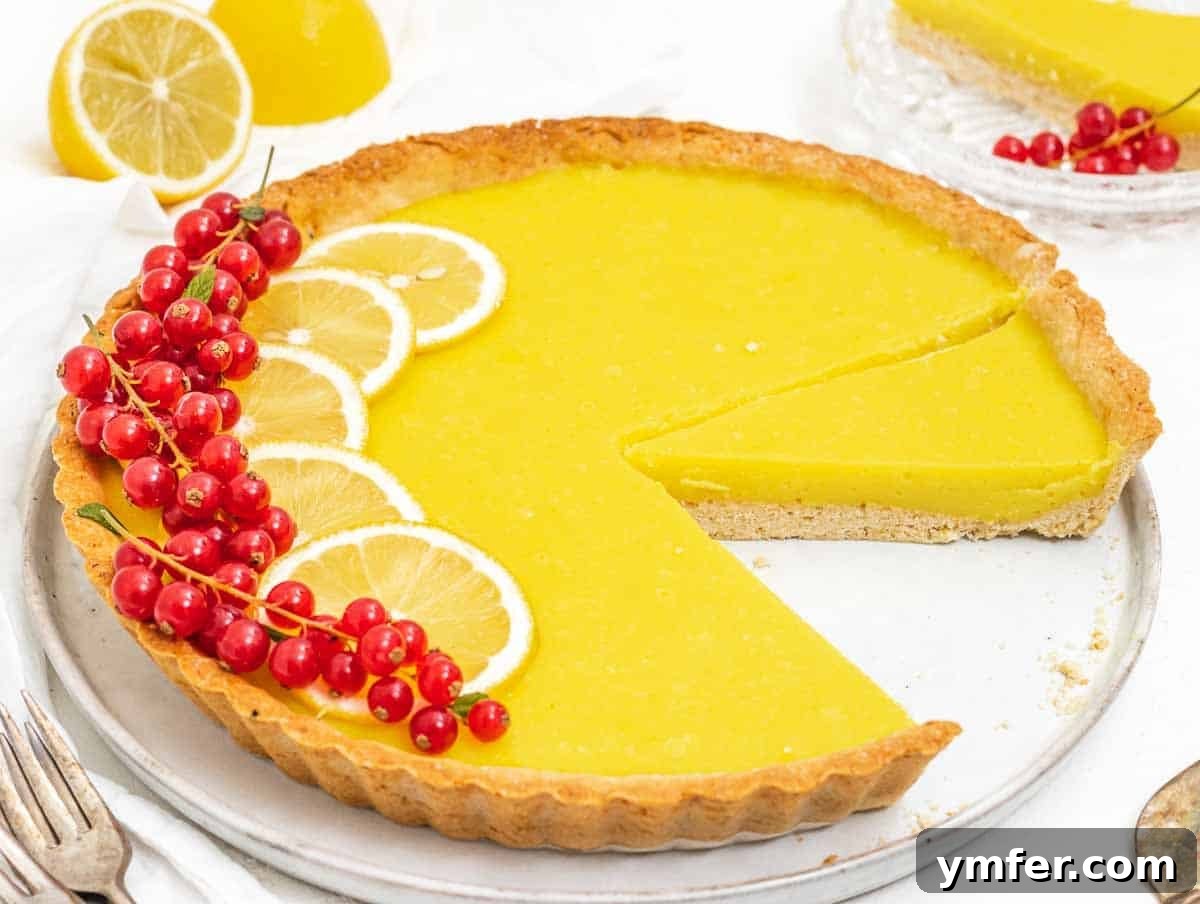 Luscious Vegan Lemon Tart 3 Lemon tart with slice and red berries