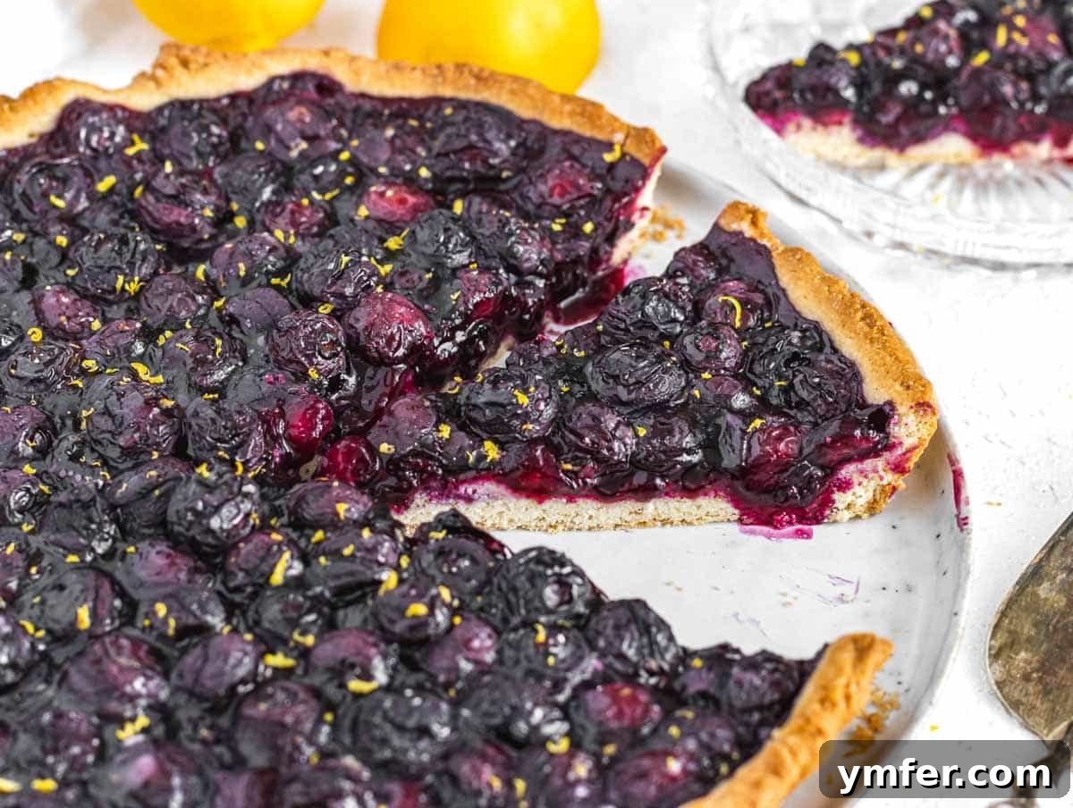 Luscious Vegan Lemon Tart 21 blueberry tart sliced on a plate
