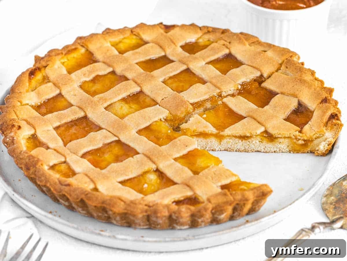 Luscious Vegan Lemon Tart 24 Crostata with slice on a white plate