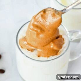 Adding the pumpkin spice whipped coffee to a mug
