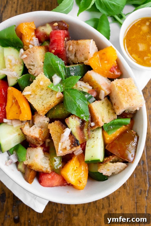Chargrilled Sourdough & Summer Vegetable Panzanella 4 grilled sourdough panzanella salad in a white bowl with dressing on the side