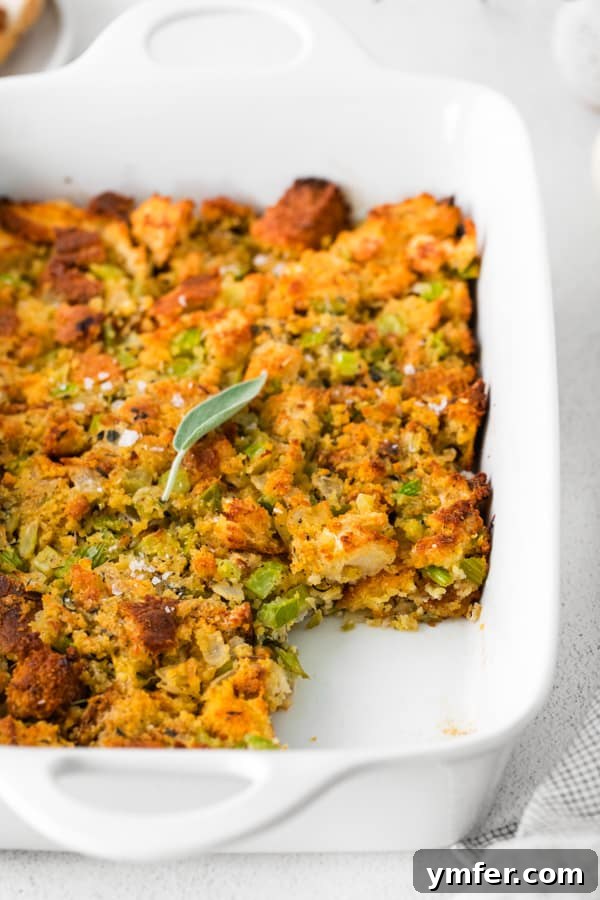 Savory Sage and Cornbread Stuffing 3 Sage and Cornbread Stuffing in a dish with a scoop removed, showing its moist interior.