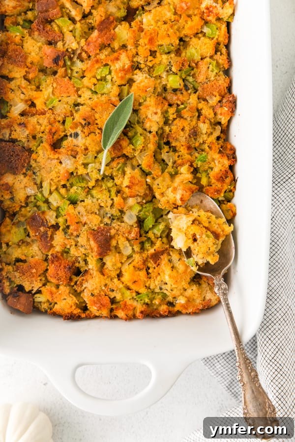 Savory Sage and Cornbread Stuffing 4 A serving of Sage and Cornbread Stuffing with a spoon, highlighting its texture.