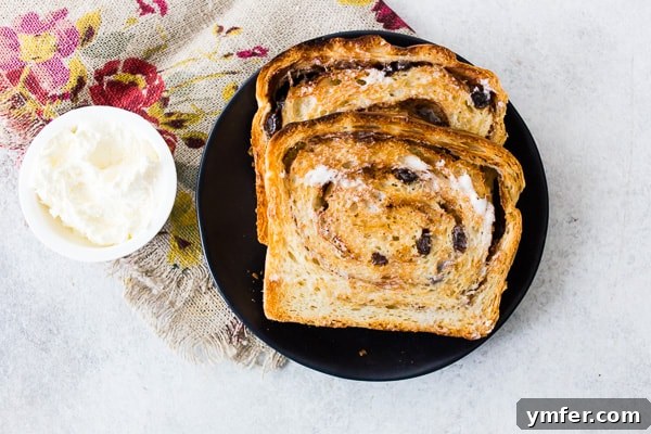 sliced cinnamon raisin sourdough bread sliced on a plate with butter