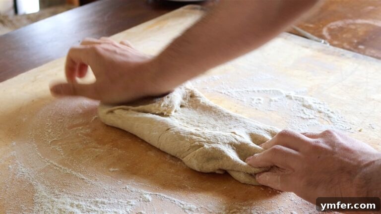 Kneading the vegan brioche dough by hand on a floured surface