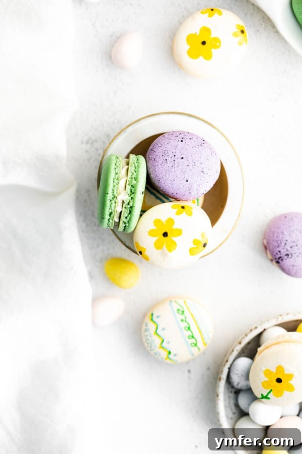 Pastel Easter Macarons 5 A vibrant assortment of Easter egg macarons, adorned with delicate painted flowers and playful speckles, nestled in a decorative bowl.