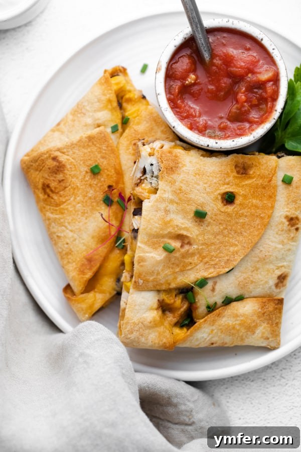 One-Pan Chicken Quesadillas 2 Crispy, golden-brown sheet pan chicken quesadillas cut into squares, ready to be served.