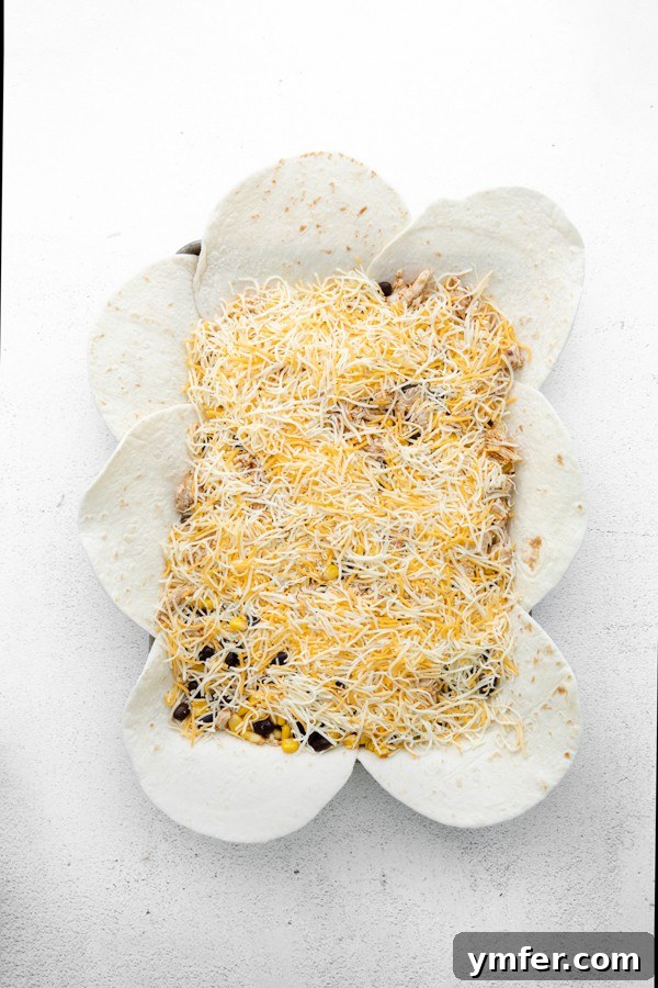 One-Pan Chicken Quesadillas 4 Uncooked sheet pan chicken quesadillas before folding, showing the layered tortillas and filling.